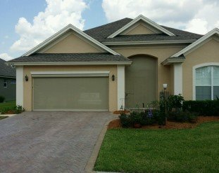 Motorized garage door screen fully extended, providing ventilation and protection from insects while allowing fresh air into the garage