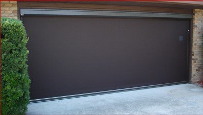 High-quality Screen America motorized garage door screen fully extended, providing ventilation and insect protection with smooth operation.