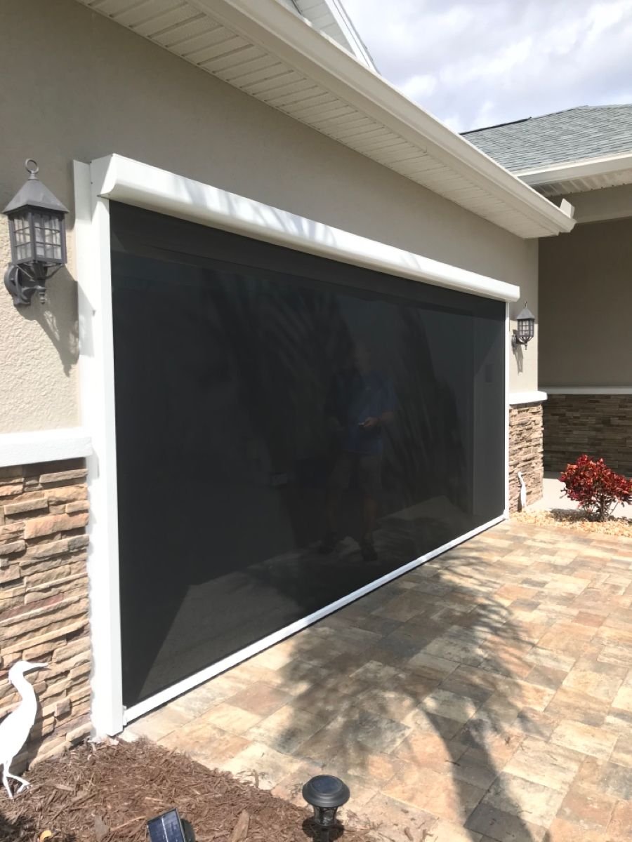 Two car garage motorized screen giving privacy and sun protection at the touch of a button