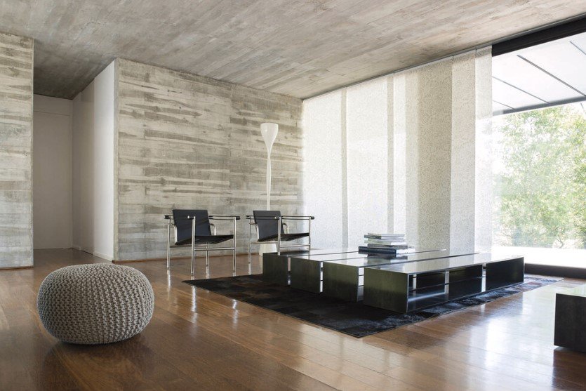 Elegant panel track shades covering large windows, providing sleek light control and a modern, minimalistic look for the room.