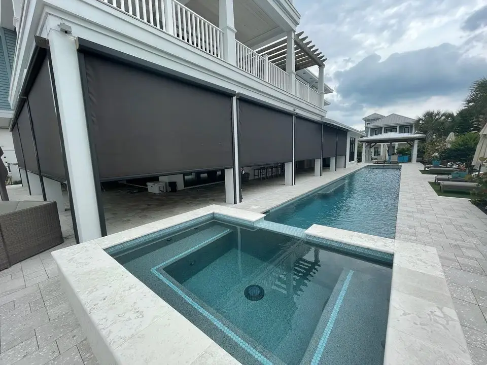 Motorized Fenetex lanai screen system with durable tracks and weather-resistant fabric installed on a Florida patio.