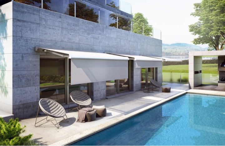 Modern patio with double motorized awnings and retractable drop shades designed for sun control and bug protection.