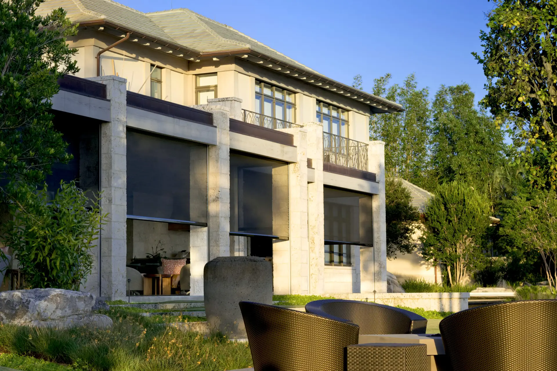 Luxury lanai with Fenetex motorized screens providing shade, privacy, and comfort in a modern Florida home.