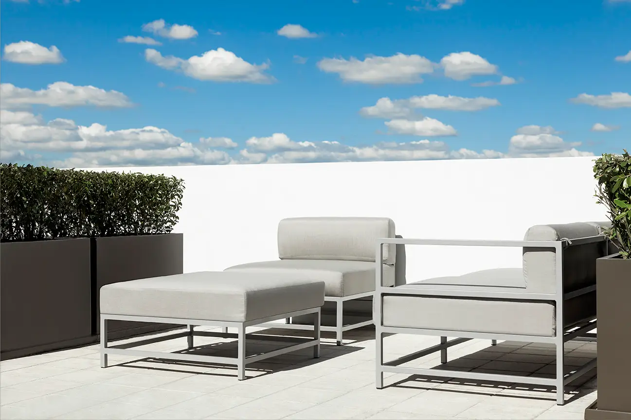 Outdoor furniture collection arranged on a spacious lanai, featuring coordinated finishes and plush seating.
