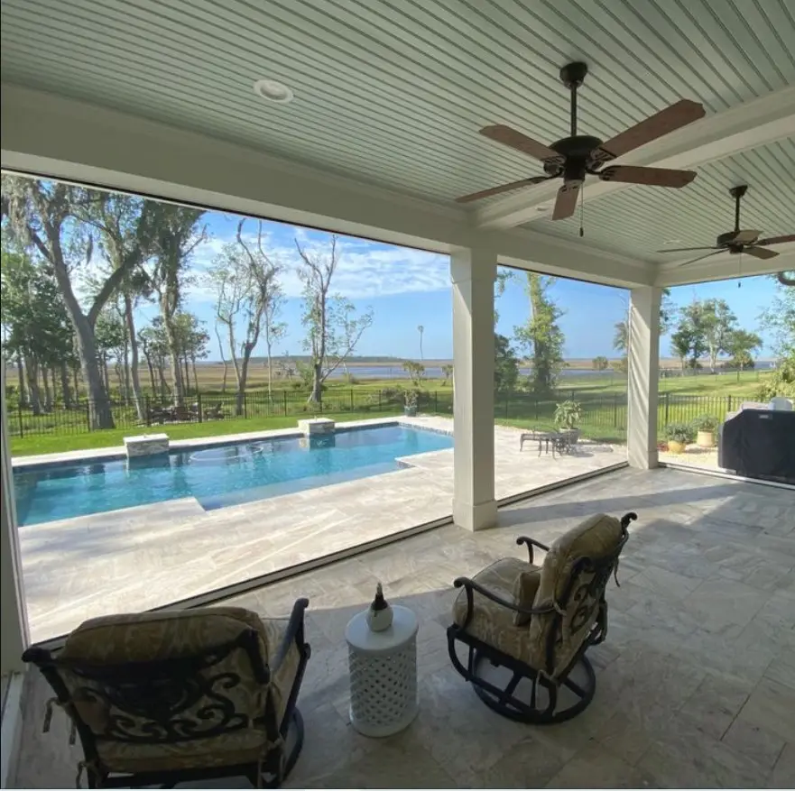 Fenetex motorized lanai screen on a Florida home providing shade, privacy, and bug protection with seamless retractable design.