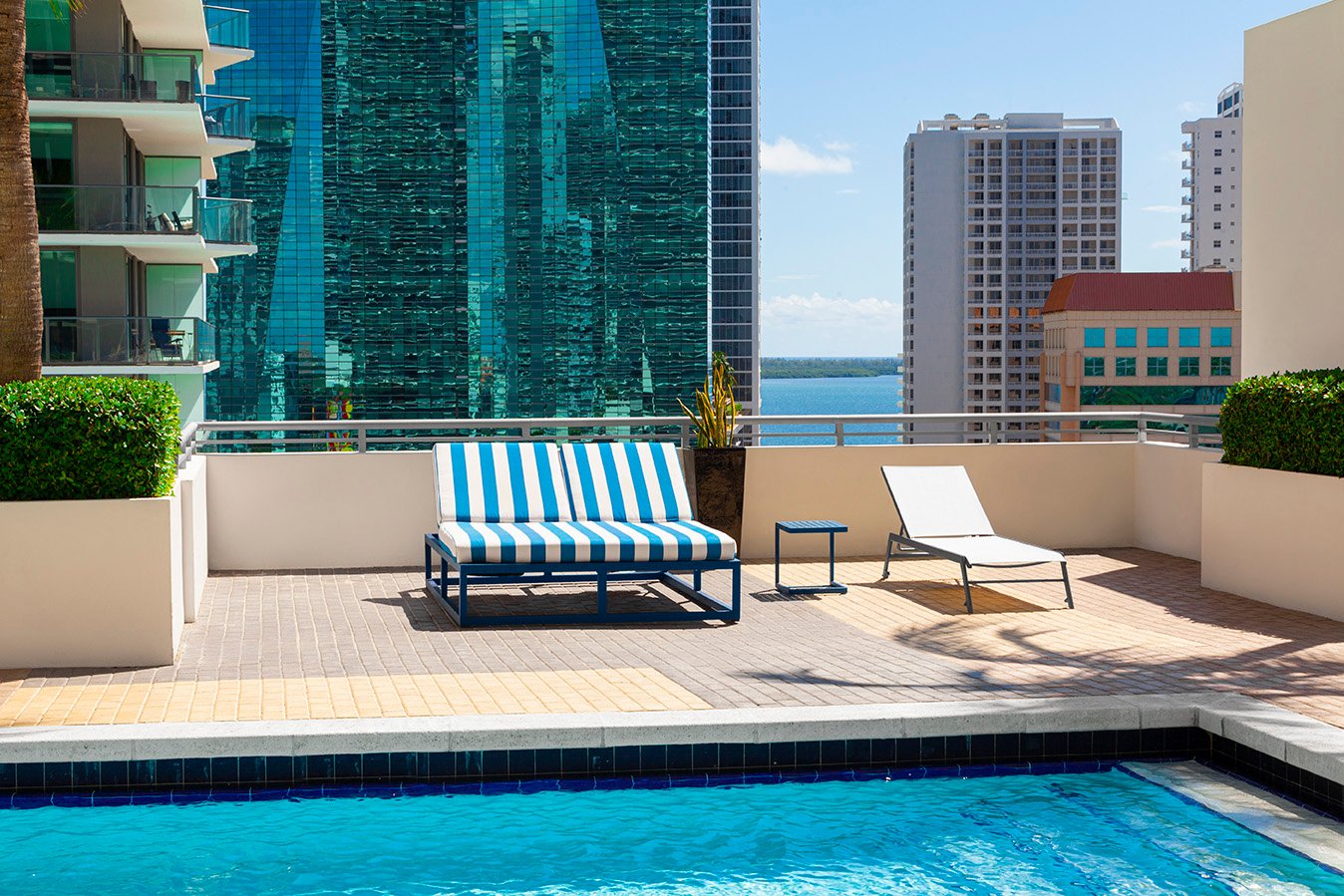 Luxury outdoor pool area featuring custom poolside furniture with stylish loungers and coordinated seating.