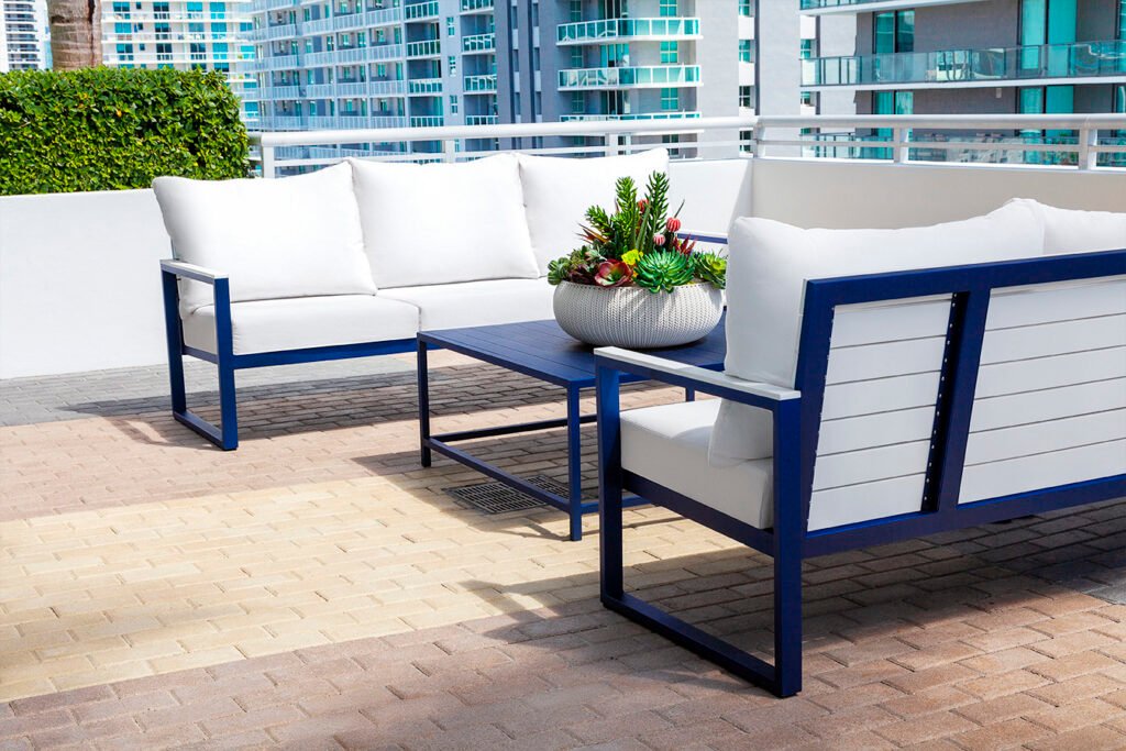 Elegant outdoor patio set featuring custom seating and a modern table, designed for stylish comfort and year-round use.