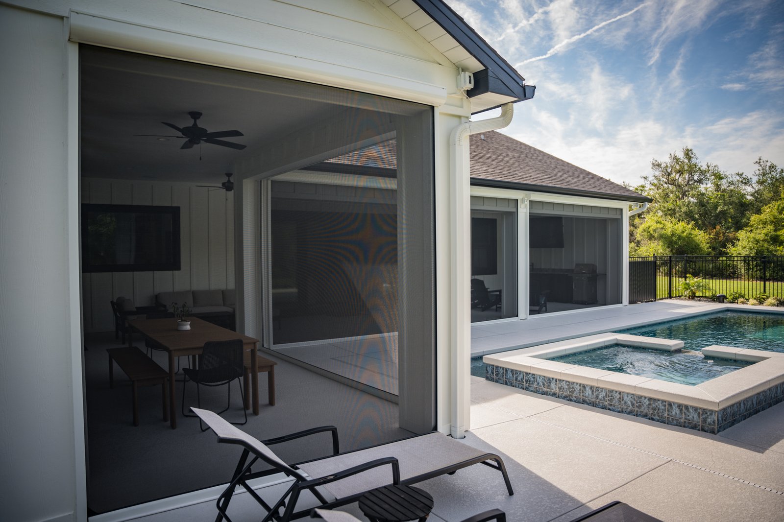 Motorized screens for a pool patio area