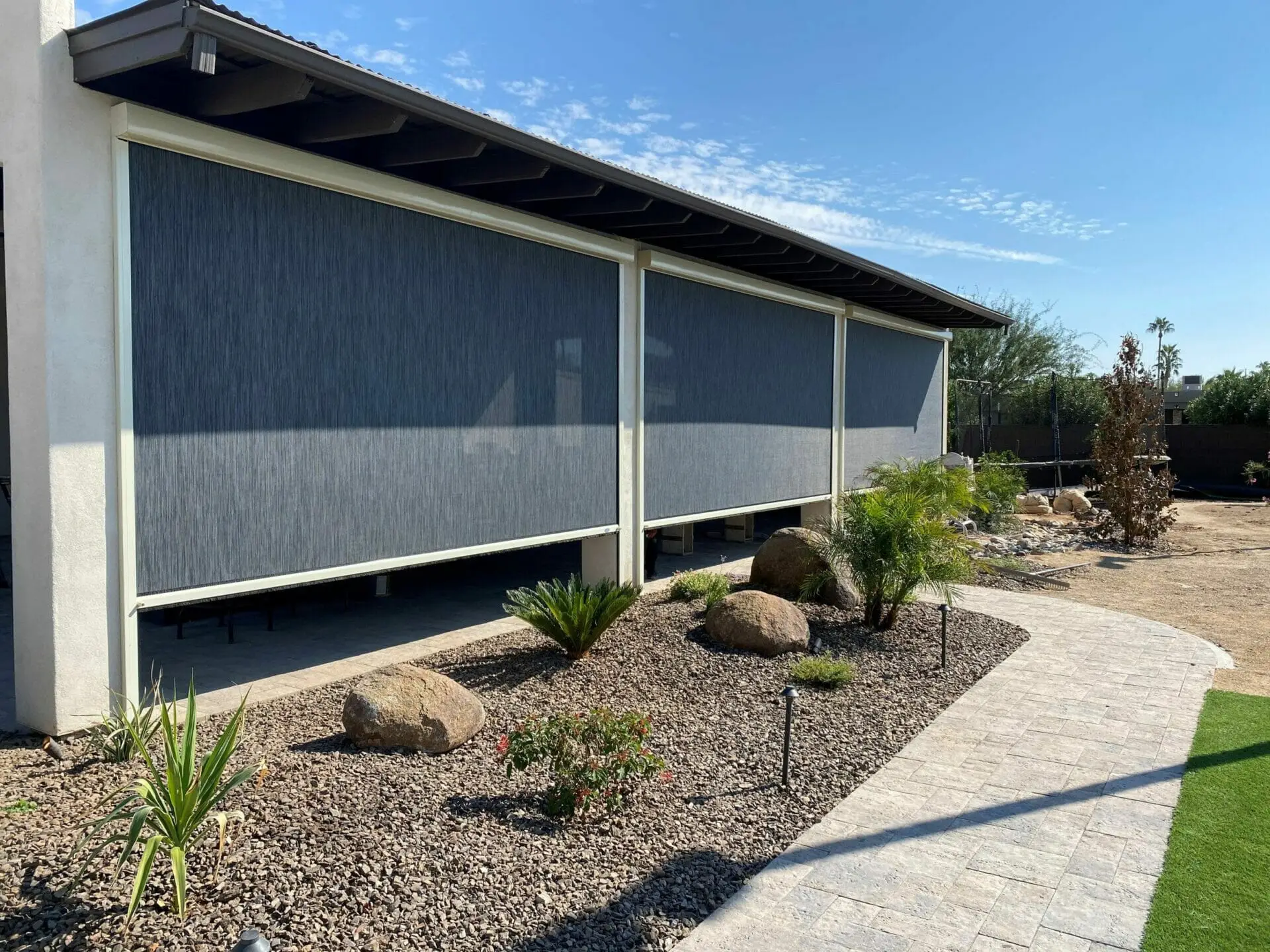 Motorized lanai screens add shade, airflow, and bug protection for a more comfortable outdoor space.